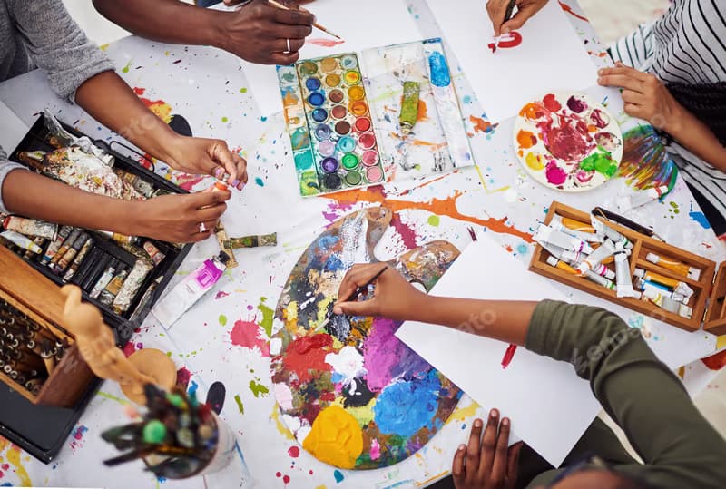 Campers having fun together during an indoor STEM and art activity at Curio Camps