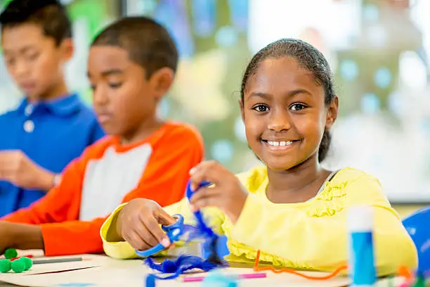 Child building confidence with support from camp staff